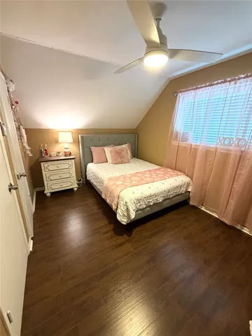 a bedroom with a bed and a night stand