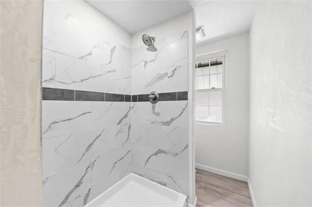 a bathroom with a bathtub and shower