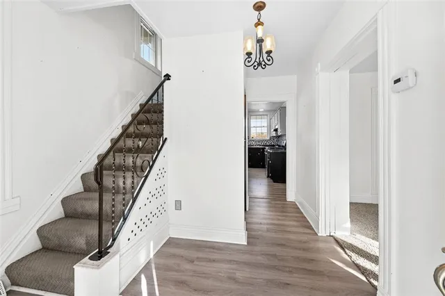 a view of entryway and hall with wooden floor
