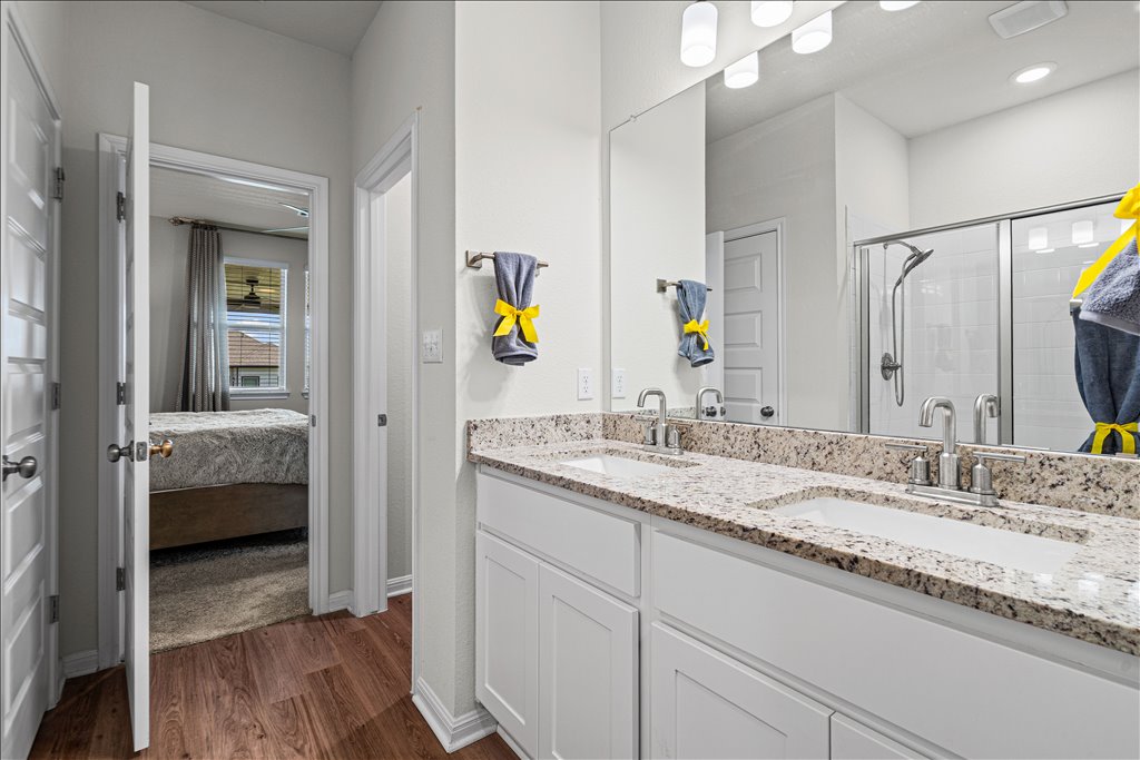 158 Gullivers Drive Elgin, TX 78621 - Photo 18 of 36 You have a double vanity featuring the same premium granite countertops we saw in the kitchen, crisp white shaker cabinets, and plenty of storage below.