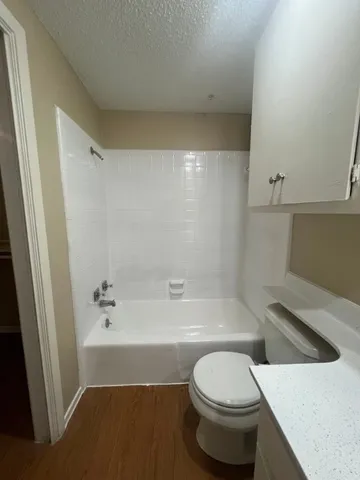 a bathroom with a sink a toilet and bathtub