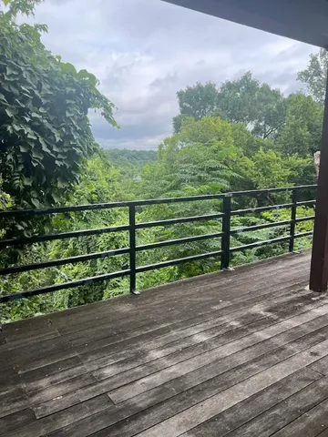 a view of a yard with wooden floor and bench