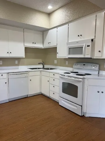 a kitchen with cabinets stainless steel appliances and sink