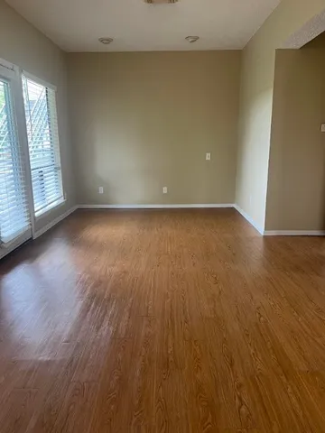 a view of a room with wooden floor and window