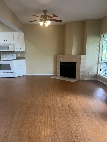 a view of kitchen with granite countertop cabinets and wooden floor