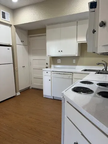 a kitchen with a sink stove and cabinets