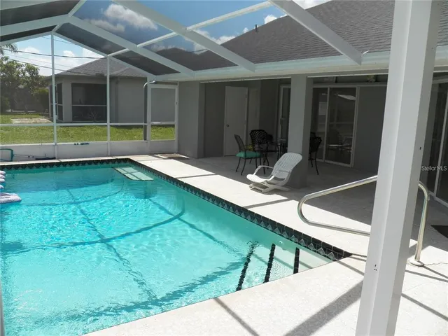 a room with view of pool table and chairs