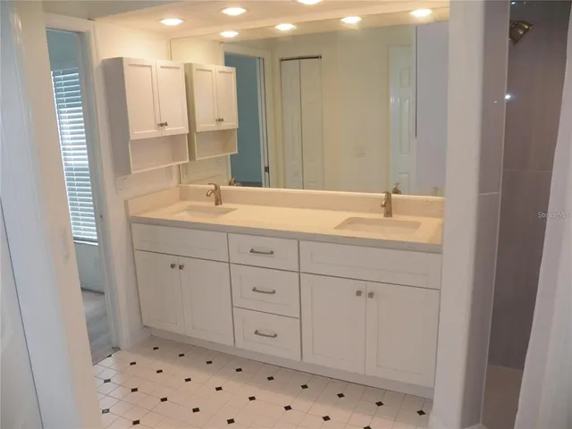 a bathroom with a sink a mirror and a shower