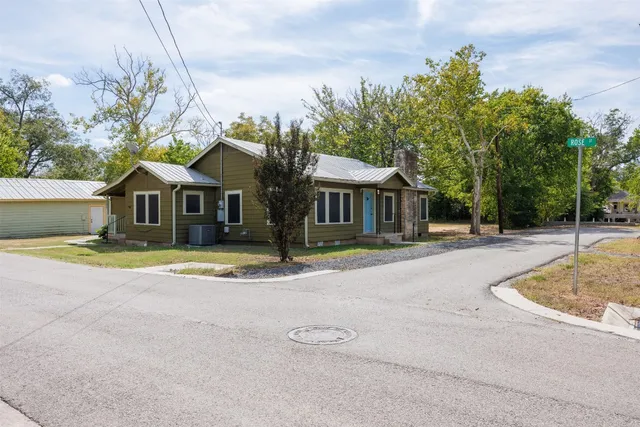 a view of house with outdoor space and swimming pool