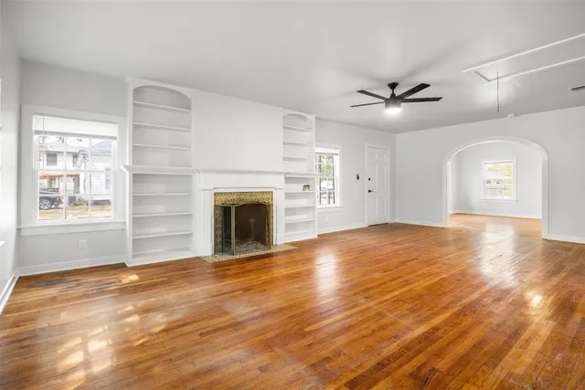 a view of empty room with cabinet and fireplace