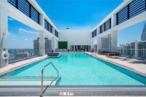 a view of a swimming pool with a lounge chairs