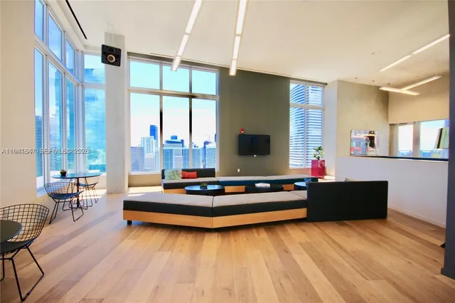 a living room with furniture and large windows