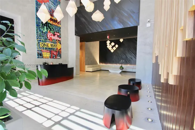 a view of a room with a floor to ceiling window and a flat screen tv