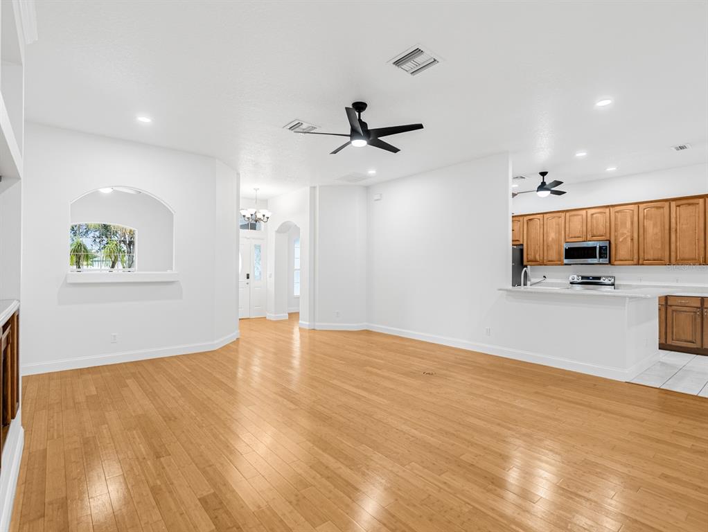 1670 Taylor Ridge Loop Kissimmee, FL 34744 - Photo 11 of 36 a view of a kitchen with microwave and a stove