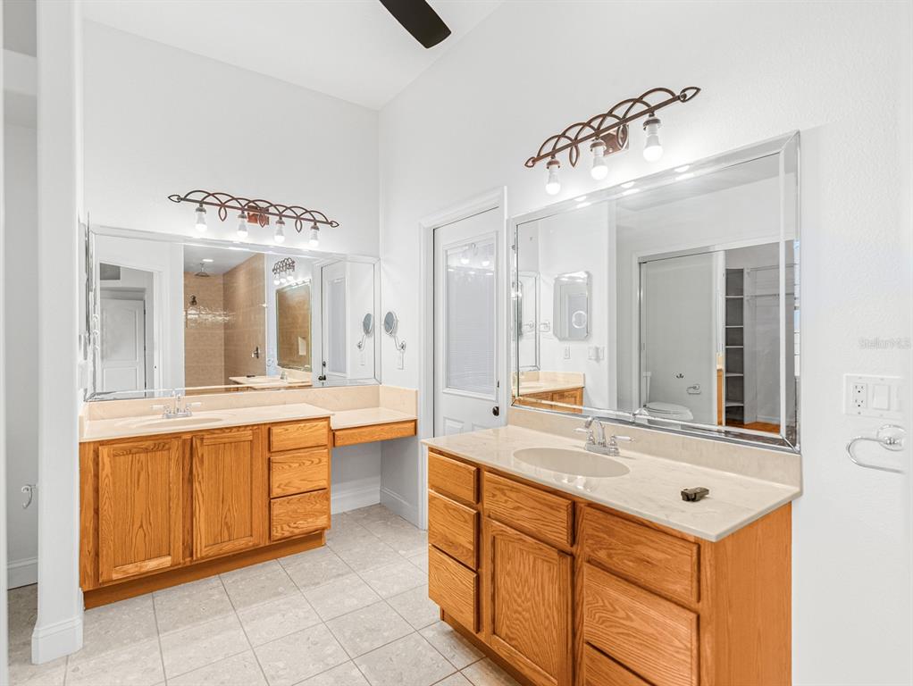 1670 Taylor Ridge Loop Kissimmee, FL 34744 - Photo 13 of 36 a bathroom with a sink vanity and mirror