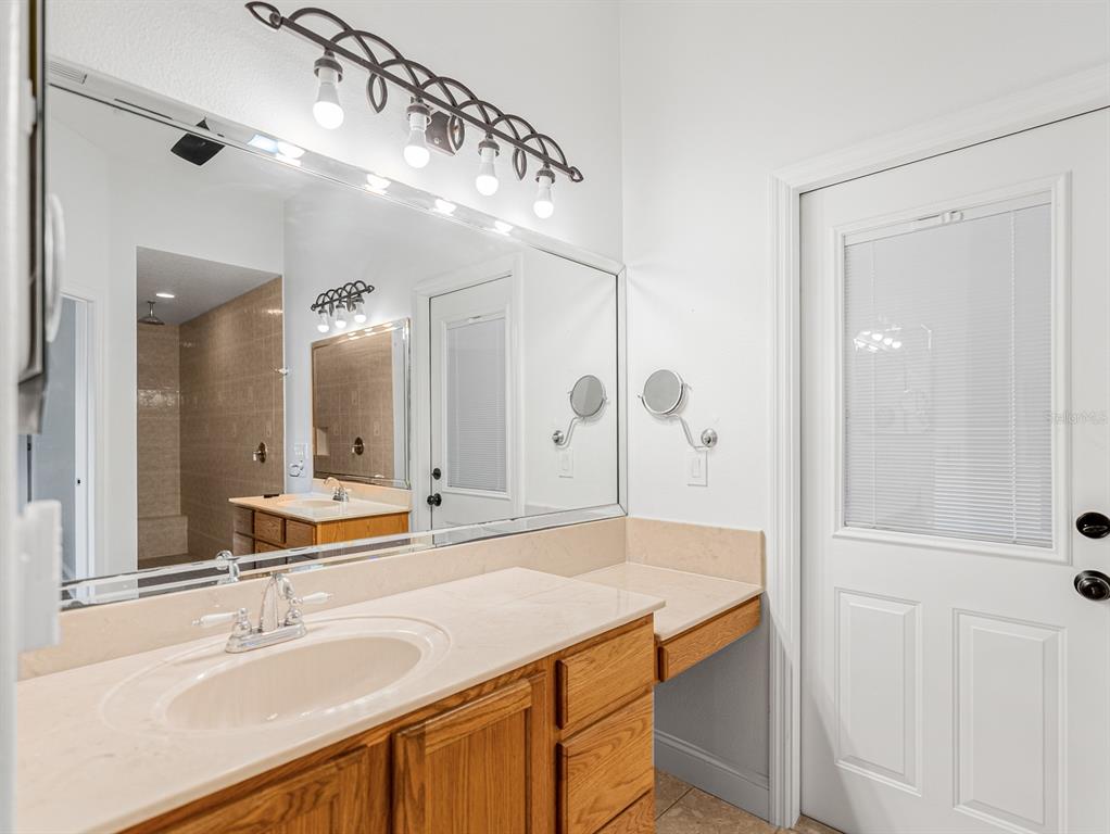 1670 Taylor Ridge Loop Kissimmee, FL 34744 - Photo 14 of 36 a bathroom with a granite countertop sink mirror and double
