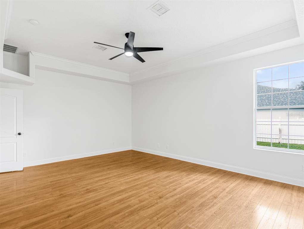 1670 Taylor Ridge Loop Kissimmee, FL 34744 - Photo 16 of 36 a view of a room with wooden floor and white walls
