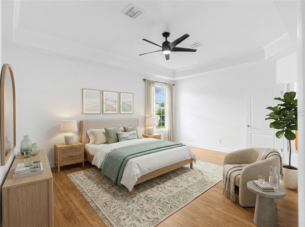 1670 Taylor Ridge Loop Kissimmee, FL 34744 - Photo 18 of 36 a bedroom with a bed and a chandelier