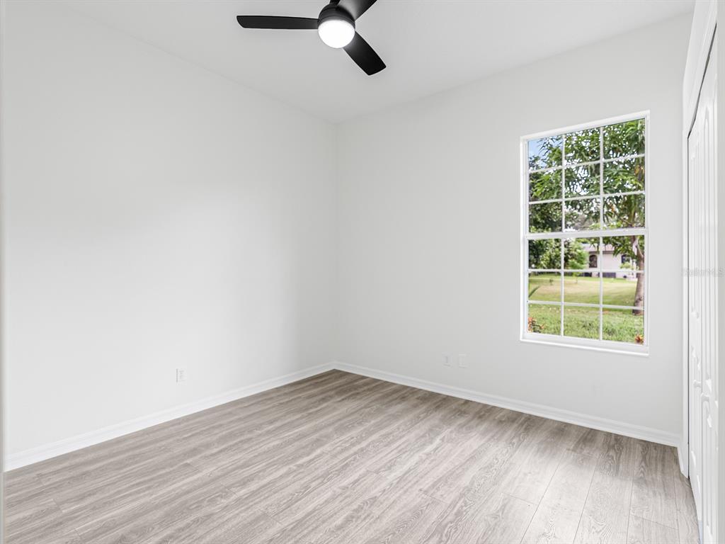 1670 Taylor Ridge Loop Kissimmee, FL 34744 - Photo 24 of 36 an empty room with wooden floor and windows