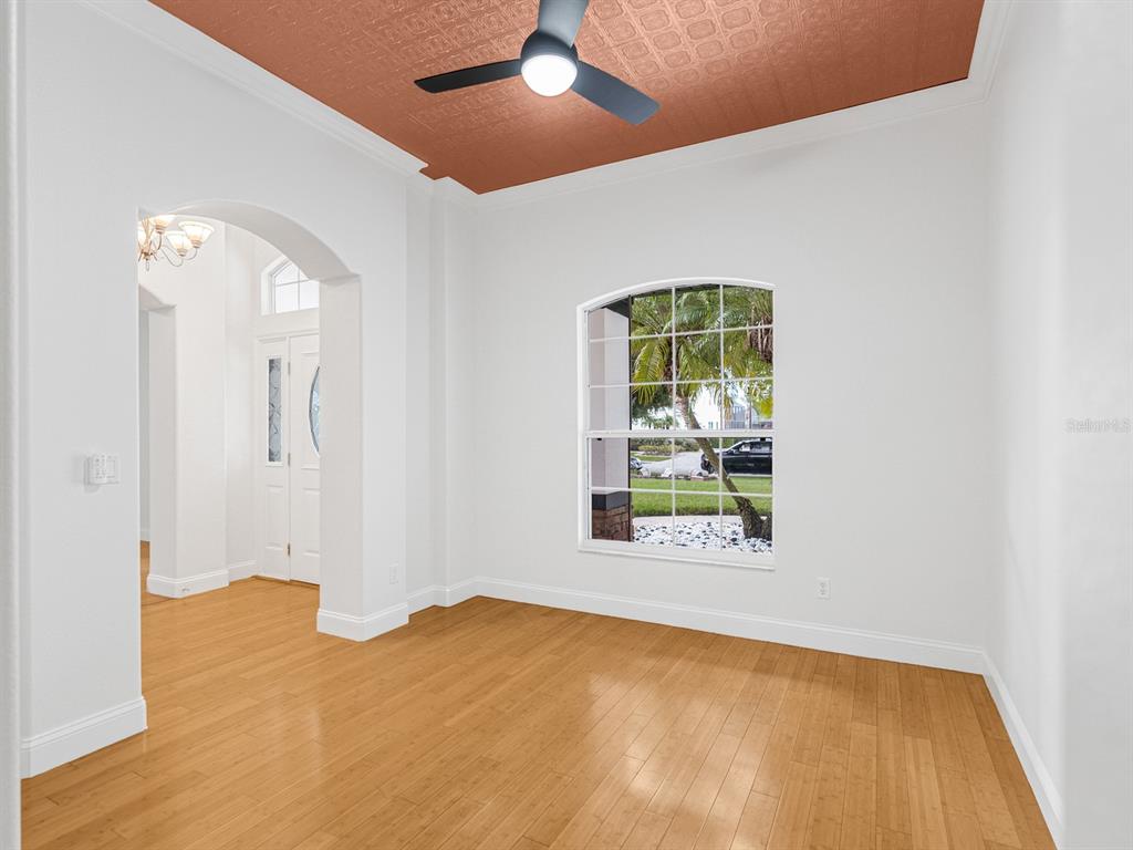 1670 Taylor Ridge Loop Kissimmee, FL 34744 - Photo 5 of 36 a view of an empty room with wooden floor and a window