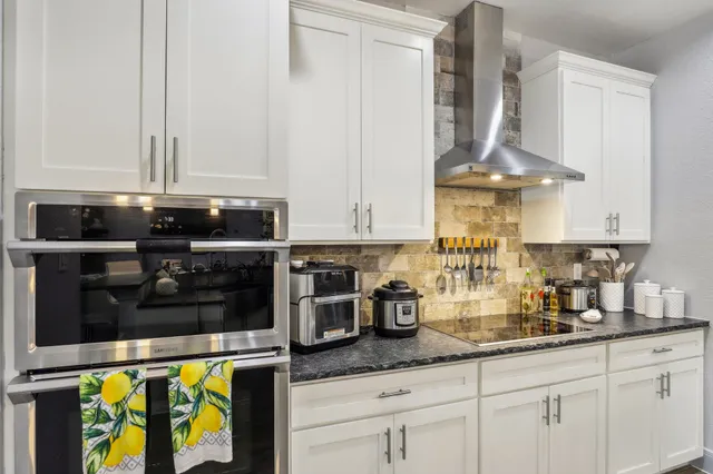 a kitchen with appliances a sink and cabinets