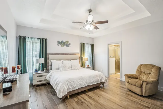 a bedroom with a bed couch and a window