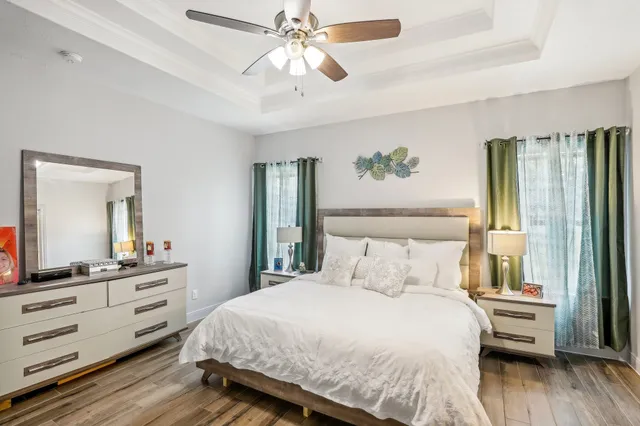 a bedroom with a large bed and a chandelier