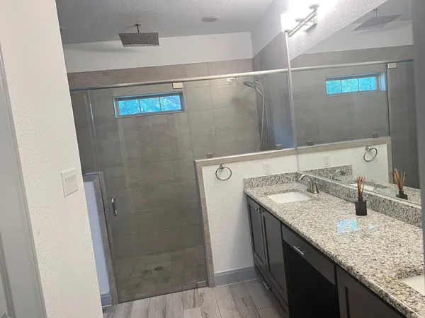 a bedroom that has a bed and a small cabinet