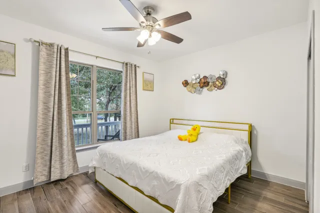 a bedroom with a bed and wooden floor