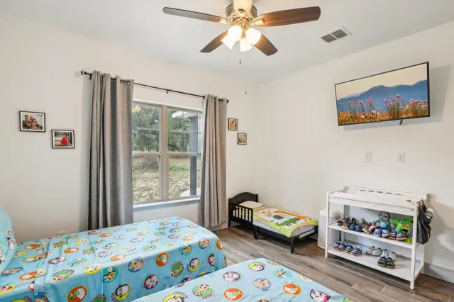 a bedroom that has a bed and a small cabinet