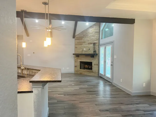 a large kitchen with stainless steel appliances granite countertop a large stove a sink and a refrigerator