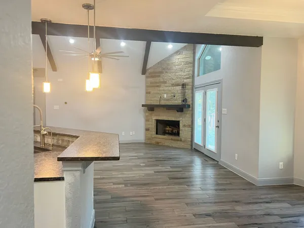 a kitchen with stainless steel appliances granite countertop stove top oven a sink and dishwasher with wooden floor