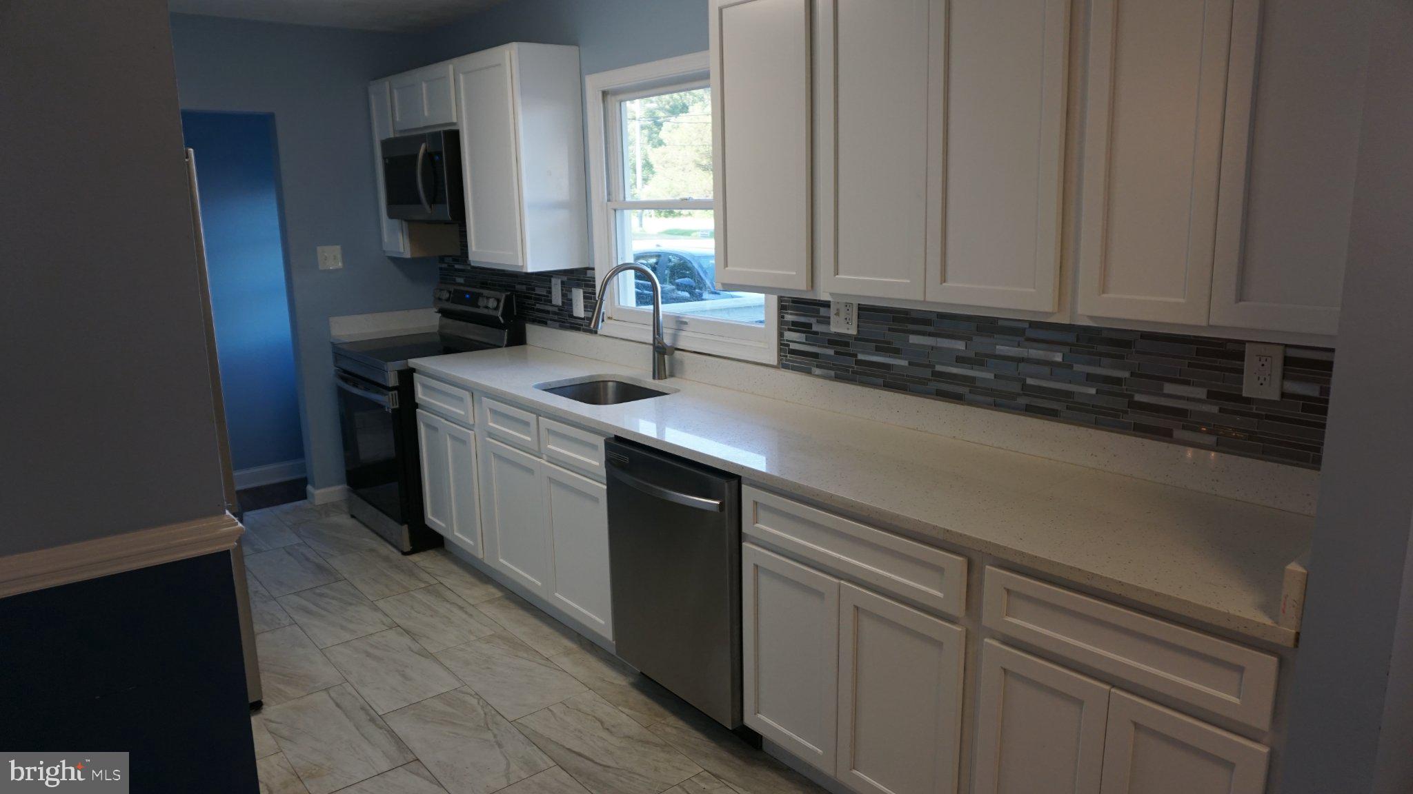 5854 Deale Churchton Road Deale, MD 20751 - Photo 14 of 57 Modern kitchen with sleek finishes.