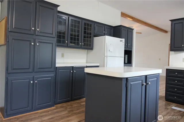a kitchen with stainless steel appliances a refrigerator and cabinets