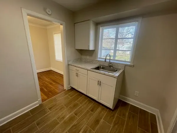 a kitchen with granite countertop a sink and a stove top oven