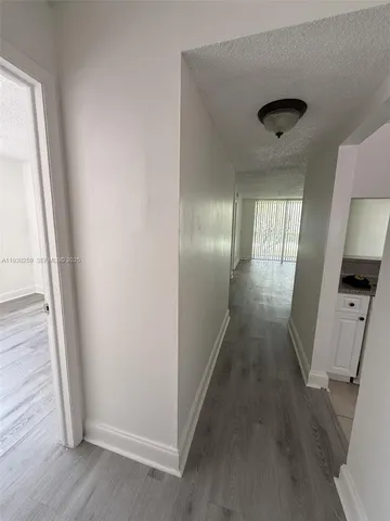 an entryway of a house with wooden floor