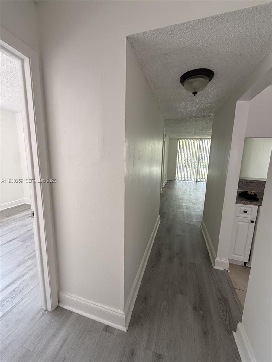 19729 Southwest 114th Avenue, Unit 251 Miami, FL 33157 - Photo 2 of 10 an entryway of a house with wooden floor