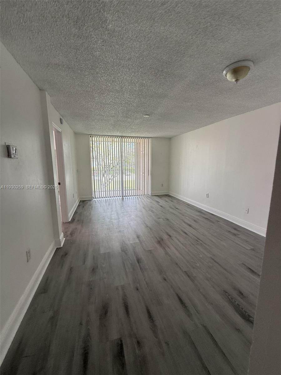 19729 Southwest 114th Avenue, Unit 251 Miami, FL 33157 - Photo 5 of 10 wooden floor in an empty room with a window