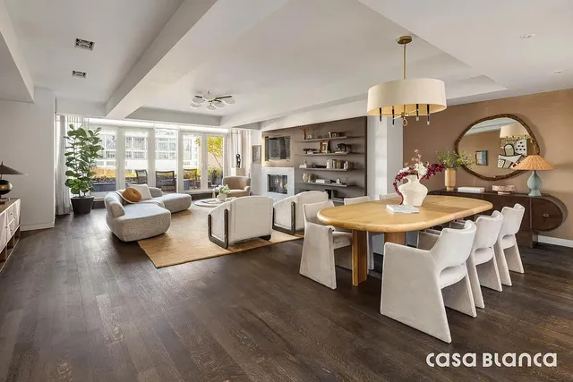 a living room with furniture a rug and a chandelier
