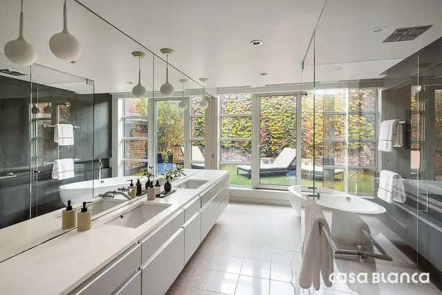 a kitchen with stainless steel appliances kitchen island granite countertop a table chairs sink and cabinets