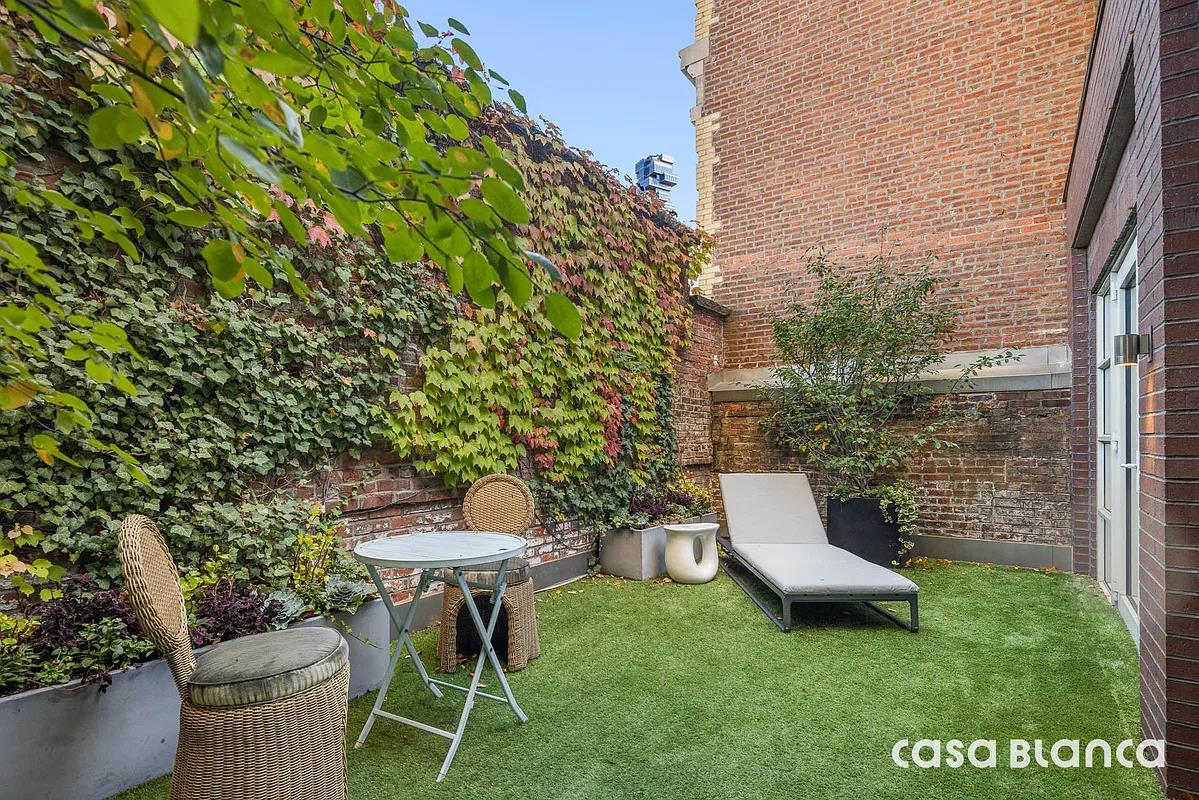 60 Collister Street, Unit PH5B Manhattan, NY 10013 - Photo 14 of 23 a view of a chair and table in backyard of the house