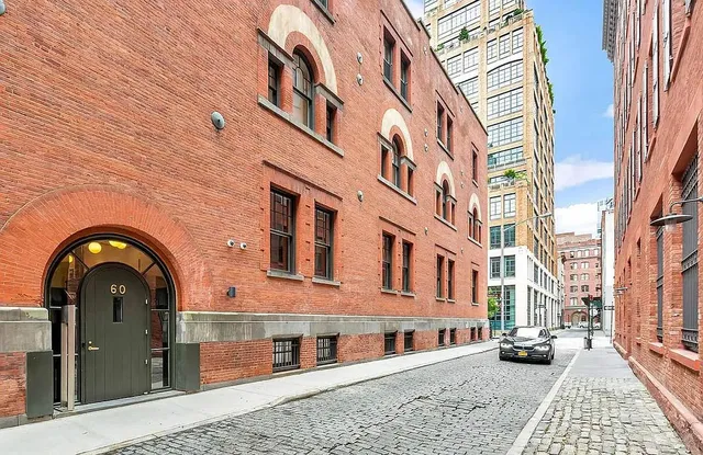 a view of a chair and table in backyard of the house