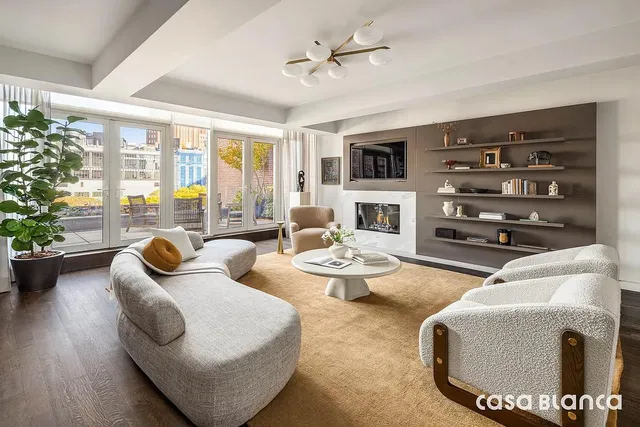 a spacious bedroom with a large bed couch and a window