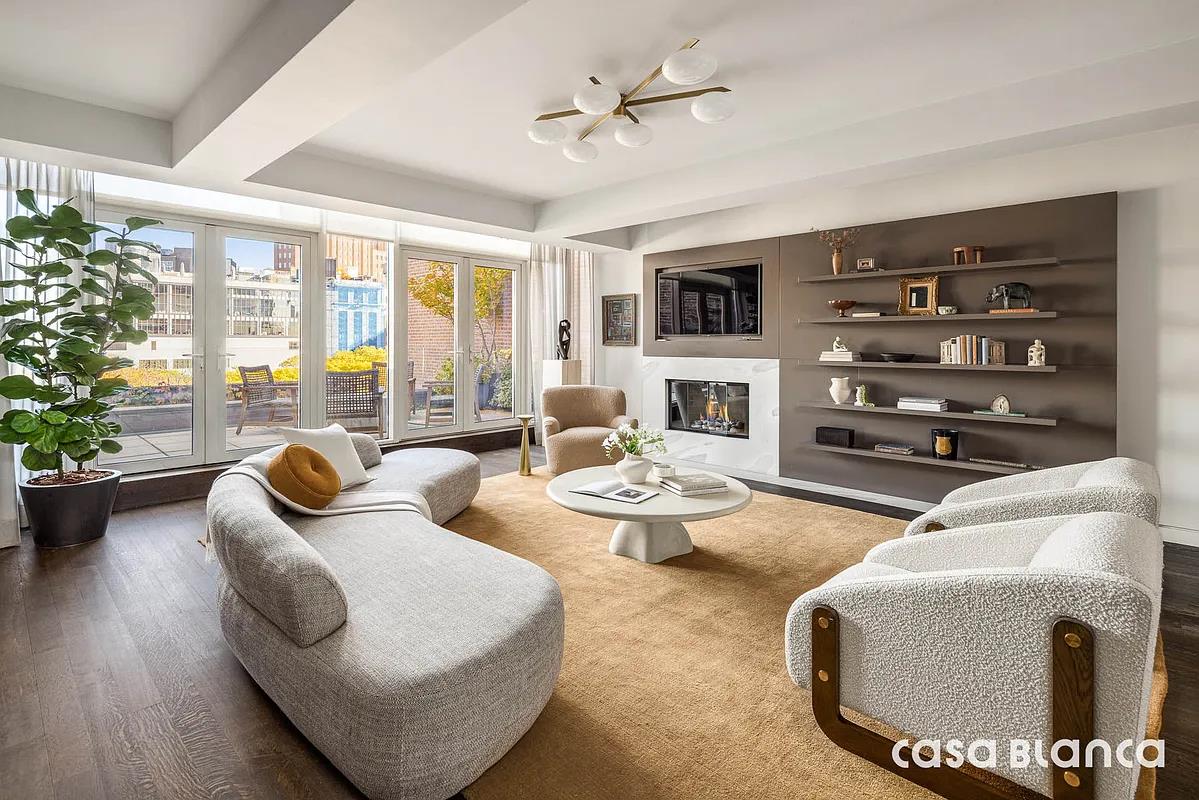 60 Collister Street, Unit PH5B Manhattan, NY 10013 - Photo 18 of 23 a living room with fireplace furniture and a floor to ceiling window