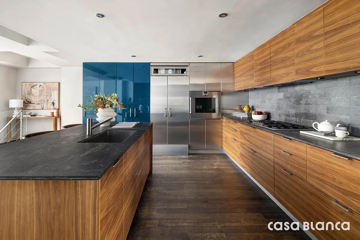 60 Collister Street, Unit PH5B Manhattan, NY 10013 - Photo 3 of 23 a kitchen with stainless steel appliances granite countertop a sink a stove and a refrigerator