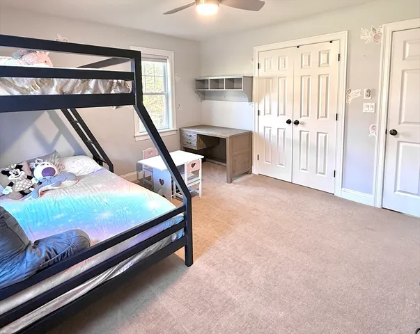 a bedroom with furniture and window