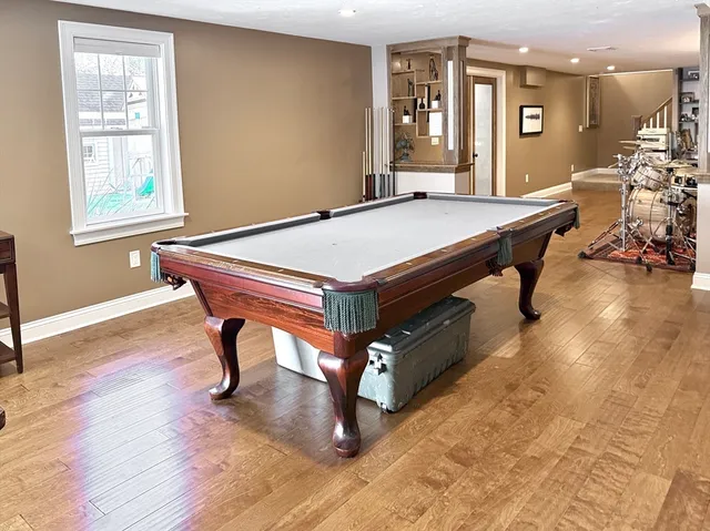 a room with pool table and windows
