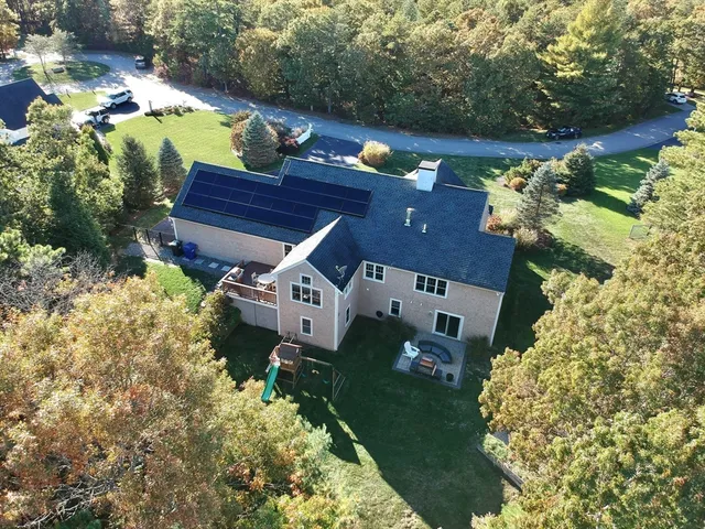 an aerial view of a house with a yard basket ball court and outdoor seating