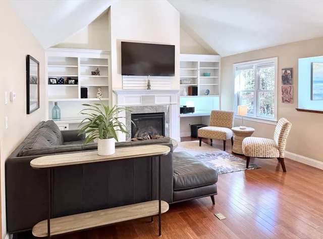 a living room with furniture fireplace and a flat screen tv