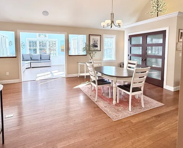 a view of a dining room with furniture wooden floor and a chandelier